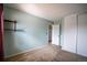 Bright bedroom featuring neutral carpet, light blue walls, and closet space at 1838 Cedar St, Broomfield, CO 80020