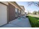 Exterior side view of a brick and siding two-story home featuring manicured lawn, attached garage, and concrete driveway at 1838 Cedar St, Broomfield, CO 80020