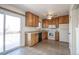 Functional kitchen with wood cabinets, appliances, and sliding glass door at 1838 Cedar St, Broomfield, CO 80020
