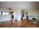 Spacious living room with hardwood floors and views into the kitchen and stairway to lower level at 1838 Cedar St, Broomfield, CO 80020
