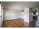 Inviting living room with gleaming hardwood floors, neutral paint, a ceiling fan, and views into the kitchen at 1838 Cedar St, Broomfield, CO 80020