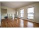 Bright living room with hardwood floors, large front windows and a decorative front door providing natural light at 1838 Cedar St, Broomfield, CO 80020