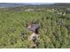 Beautiful aerial view of a house surrounded by dense trees, creating a peaceful and private retreat at 17940 Smugglers Rd, Monument, CO 80132