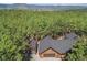 Stunning aerial view of a cozy log cabin home nestled in a lush forest setting with mountain views at 17940 Smugglers Rd, Monument, CO 80132