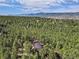 Captivating aerial perspective of a home surrounded by a lush forest, offering breathtaking views of the landscape at 17940 Smugglers Rd, Monument, CO 80132