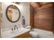 Bathroom with modern fixtures, wood paneling and a shower-tub combo at 17940 Smugglers Rd, Monument, CO 80132