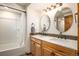 Bright bathroom with double sink vanity, undermount sinks, and shower tub combo at 17940 Smugglers Rd, Monument, CO 80132