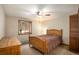 Comfortable bedroom featuring a ceiling fan, window with trees, and closet at 17940 Smugglers Rd, Monument, CO 80132