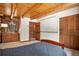 Bedroom featuring log walls, a wooden dresser, and a large closet space at 17940 Smugglers Rd, Monument, CO 80132