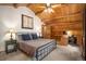 Cozy bedroom with vaulted wood ceiling, built in desk, and large statement clock at 17940 Smugglers Rd, Monument, CO 80132