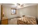 Comfortable bedroom with ceiling fan, dresser, and window with sunlight at 17940 Smugglers Rd, Monument, CO 80132