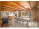 Open dining area with wood beam ceiling and large windows providing natural light and forest views at 17940 Smugglers Rd, Monument, CO 80132