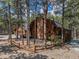Beautiful log home with brick chimney encircled by rustic wood fence at 17940 Smugglers Rd, Monument, CO 80132