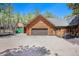 Garage of log home plus matching detached storage shed on gravel driveway at 17940 Smugglers Rd, Monument, CO 80132