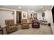 Basement living room features carpeted floors, a staircase, and three cozy armchairs at 17940 Smugglers Rd, Monument, CO 80132