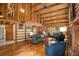 Open-concept living room with fireplace, built-in shelves, and natural wood finishes at 17940 Smugglers Rd, Monument, CO 80132