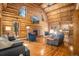 Inviting living room boasts high ceilings, hardwood floors, and brick fireplace at 17940 Smugglers Rd, Monument, CO 80132