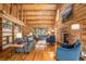 Bright living room with vaulted ceilings, wood beams, and a cozy fireplace at 17940 Smugglers Rd, Monument, CO 80132
