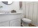 Bathroom featuring wood look floor, framed mirror, and bright counter space at 8678 Mariposa St, Thornton, CO 80260