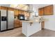 Well-lit kitchen with stainless steel appliances, warm wood cabinets, and a functional island at 8678 Mariposa St, Thornton, CO 80260
