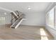Bright living room with a staircase, hardwood floors, and natural light from a large window at 8678 Mariposa St, Thornton, CO 80260