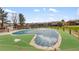 Community pool covered for the off season, surrounded by turf and brick perimeter fencing at 8678 Mariposa St, Thornton, CO 80260