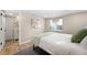 Cozy bedroom with hardwood floors, a bright window and neutral colored walls and modern style at 1534 Meade St, Denver, CO 80204