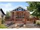 Charming brick home with a picket fence and a welcoming covered porch entrance at 1534 Meade St, Denver, CO 80204