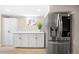A modern kitchen with stainless steel refrigerator, white cabinets, quartz countertops, and hardwood floors at 1534 Meade St, Denver, CO 80204