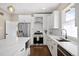Updated kitchen featuring stainless steel appliances, an island with marble countertops and white cabinetry, plus a subway tile backsplash at 1534 Meade St, Denver, CO 80204