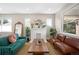 Cozy living room with large windows, stylish sofas, and a decorative fireplace at 1534 Meade St, Denver, CO 80204