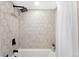 Modern shower with hexagon tile surround, sleek fixtures and rain style shower head at 1534 Meade St, Denver, CO 80204