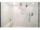 A modern shower features marble tiles, a glass enclosure, a rainfall showerhead, and a built-in niche at 1534 Meade St, Denver, CO 80204
