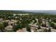 High angle of homes nestled within a tree filled neighborhood near a tranquil lake setting at 8595 Field Ct, Arvada, CO 80005