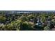 Aerial view of neighborhood with mature trees and a lake in the distance at 8595 Field Ct, Arvada, CO 80005