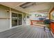 View of the covered back deck with sliding glass door access to the home's interior at 8595 Field Ct, Arvada, CO 80005