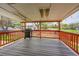 The spacious covered deck features wood railings and provides a great space for entertaining outdoors at 8595 Field Ct, Arvada, CO 80005