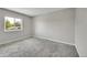 Bedroom featuring soft carpet, neutral colors, and a large window at 8595 Field Ct, Arvada, CO 80005