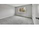 Bright bedroom features soft carpet, neutral colors, and a window with tree views at 8595 Field Ct, Arvada, CO 80005