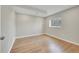 Bright bedroom with wood flooring, a window, and electrical outlets at 8595 Field Ct, Arvada, CO 80005