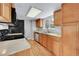 Cozy kitchen featuring an oven, wood cabinets and stainless steel dishwasher at 8595 Field Ct, Arvada, CO 80005