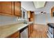 Kitchen with stainless steel dishwasher and wood cabinets at 8595 Field Ct, Arvada, CO 80005
