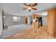 Cozy living room with new carpet flows into kitchen with stainless steel appliances and wood floors at 8595 Field Ct, Arvada, CO 80005