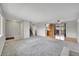 Bright living room flows into dining area with sliding doors to the outdoor deck at 8595 Field Ct, Arvada, CO 80005