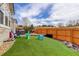 The backyard features artificial grass, a sandbox, and a seating area, ideal for and entertaining at 11081 Cannonade Dr, Parker, CO 80138