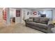 The basement features a comfortable gray sofa and a bathroom, ideal for recreation or relaxing at 11081 Cannonade Dr, Parker, CO 80138