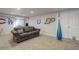 The basement features a comfortable sofa and sports themed decor, ideal for recreation or entertainment at 11081 Cannonade Dr, Parker, CO 80138