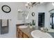 Bright bathroom featuring double sinks, a large mirror, and ample counter space at 11081 Cannonade Dr, Parker, CO 80138