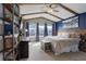 Serene bedroom with vaulted ceilings, wooden beams, and an abundance of natural light, creating a relaxing atmosphere at 11081 Cannonade Dr, Parker, CO 80138