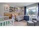 Adorable Bedroom with twin cribs, a cozy chair, and natural light, perfect for little ones at 11081 Cannonade Dr, Parker, CO 80138